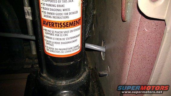 strobewirefromdriverside.jpg Driver side wire run down the brake light housing area, through a rectangular floor support tube then back up forward of the passenger side brake light housing area (through a plastic cover) and into the jack area via this mystery hole.