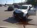 1993 Ford Mustang - A silver SUV sustained significant front-end damage after an apparent collision, with fluid leaking onto the road.