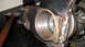 1996 Ford Bronco - A hammer rests near a differential housing, showing signs of wear and rust.