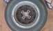 1991 Ford Festiva - A close-up view of a single wheel and tire, showing rust on the wheel's center hub.