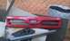 1991 Ford Festiva - This is a Ford grille, possibly from a 1991 model, with a jack visible underneath.