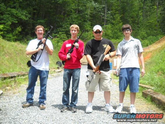 Four men with firearms at a shooting range