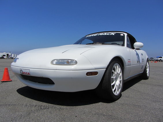 White 1991 Mazda Miata with 'Tire Rack' banner and '30' racing number