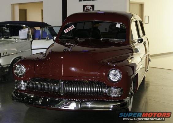 Maroon custom wagon front view with "SOLD" sign on windshield