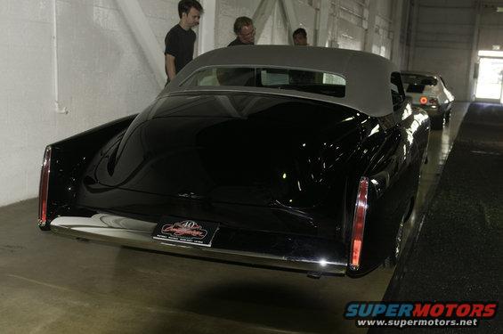 Black convertible rear view with a license plate that reads "40th Anniversary"
