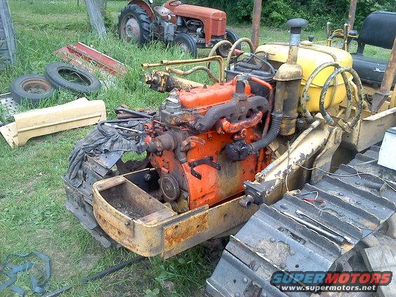 Yellow tractor engine with orange block and yellow tank