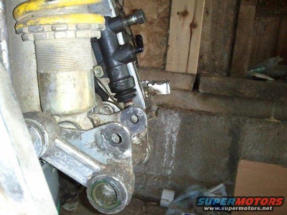 Motorcycle rear suspension with GASGAS branding on linkage