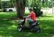 2008 Yamaha Zuma - A man rides a black scooter with a 'Velocity' sticker in a grassy area.