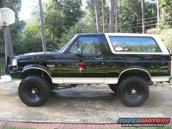 1993 Ford Bronco, black with white top, lifted suspension, side view