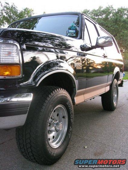Black 1994 Ford Bronco with tan lower trim, chrome accents, and alloy wheels
