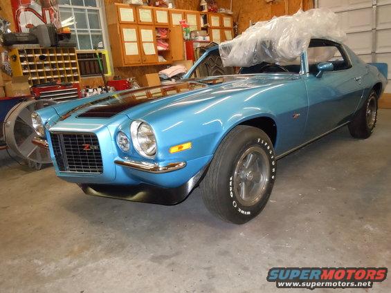 Blue 1970 Chevrolet Camaro Z28 with black racing stripes, parked in a garage