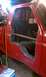 1994 Ford F-250 - Custom metalwork is visible inside the cab of a red pickup truck, near the driver's side door.