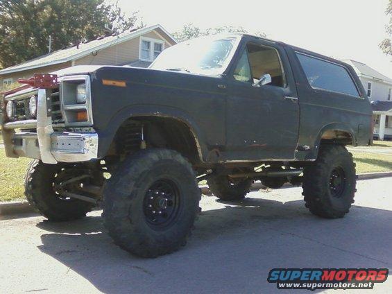 Lifted black Ford Bronco with aftermarket bumper and large tires