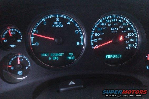 Dashboard gauges showing RPM, MPH, fuel level, and instant economy. PRND321 is displayed