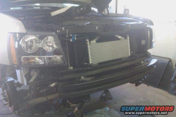2007 Chevrolet Tahoe front end with hood open, showing exposed engine components and aftermarket intercooler