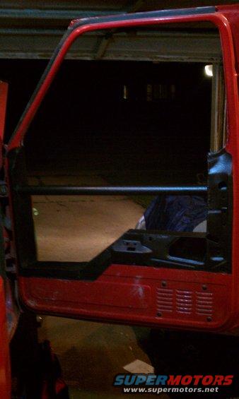 red truck door frame, open, showing interior structure and a dark interior space