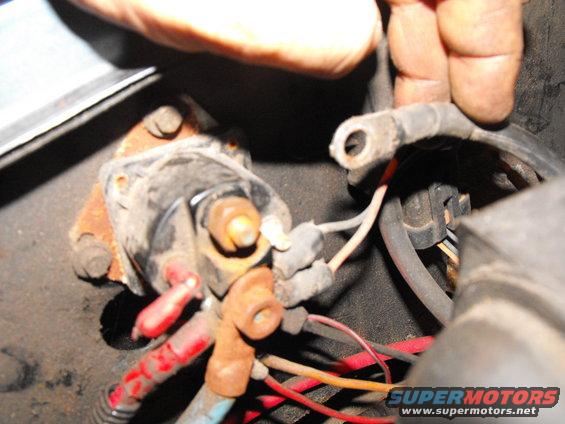 Here's the 2 gauge, stock starter cable being removed from the top post in preparation for mounting it onto the lower (always hot) post. The starter will not start because there is no signal being sent to it yet (that and you disconnected teh battery right?).