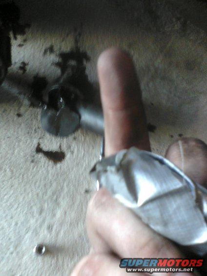 Mechanic's hand with rag near bolt