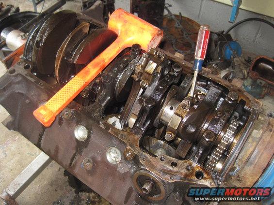 Engine block with crankshaft, connecting rods, and orange mallet