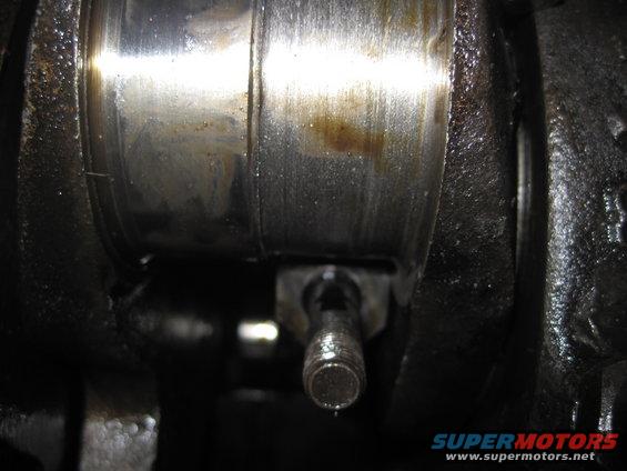 Close-up of an engine crankshaft bearing with oil residue