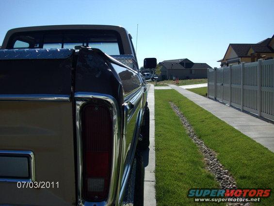 Tan and brown 1979 Ford F-150 pickup truck, rear driver side view, chrome trim, diamond plate tool box