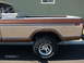 1979 Ford F-150 - This 1979 Ford F-150 pickup features a two-tone brown and tan paint scheme on its bed and cab.