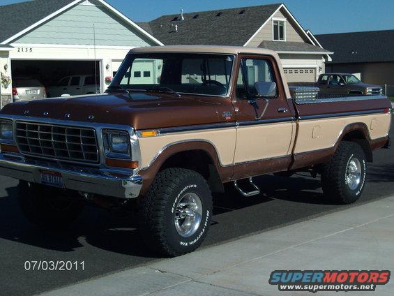 Brown and tan 1979 Ford F-150 pickup truck with chrome grille and aftermarket wheels, parked in driveway