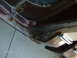 1979 Ford F-150 - Close-up of a heavily rusted door jamb on a brown vehicle, showing extensive corrosion and damage.