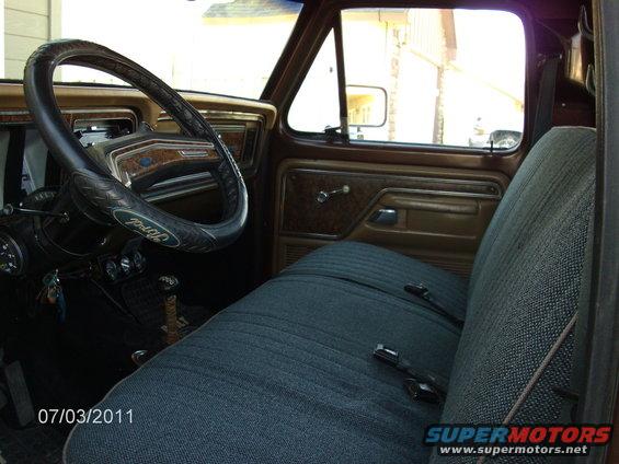 Interior view of a 1979 Ford F-150, showing the dashboard, steering wheel, and bench seat