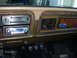 1979 Ford F-150 - Close-up of a vehicle's dashboard, showing the climate controls, an aftermarket stereo, and a Ford emblem.