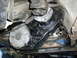 1979 Ford F-150 - Underside view of a vehicle's transfer case, showing its black housing and a silver circular cover.