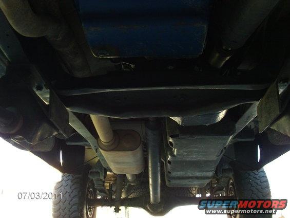 Undercarriage view of a truck with visible exhaust and suspension components