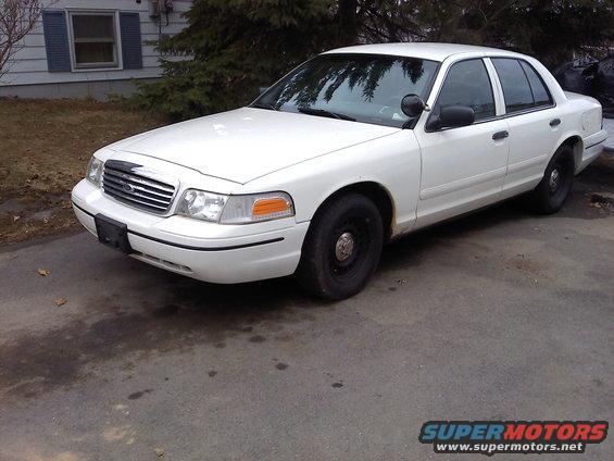White 2000 Ford Crown Victoria sedan parked on asphalt driveway