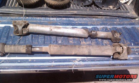 Two driveshafts and differential gears in a truck bed