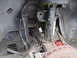 1992 Ford Taurus - Close-up view of the front suspension and brake assembly, including the strut, CV axle, and rotor. The SuperMotors.net logo is visible at t…