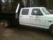 1997 Ford F-350 - Side view of a white 1997 Ford F-350 crew cab truck with a flatbed.