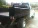 1997 Ford F-350 - This 1997 Ford F-350 pickup features a flatbed with integrated black toolboxes and dual rear wheels.