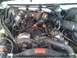 1997 Ford F-350 - The engine bay of a vehicle, showing various components and a warning sticker on the fan shroud.
