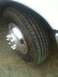 1997 Ford F-350 - Close-up of a truck wheel and tire, showing the chrome hubcap and tread pattern.