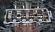 1991 Ford Festiva - Close-up view of an engine's internal components, including the camshaft and valves, with the valve cover removed.