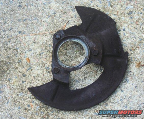 rusty metal brake dust shield with a circular bearing race