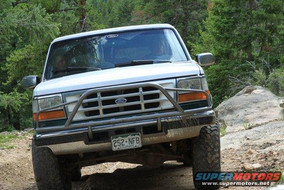 White 1996 Ford Bronco with brush guard on a rocky trail