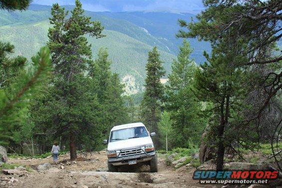 White 1992 Ford Bronco on a rocky mountain trail