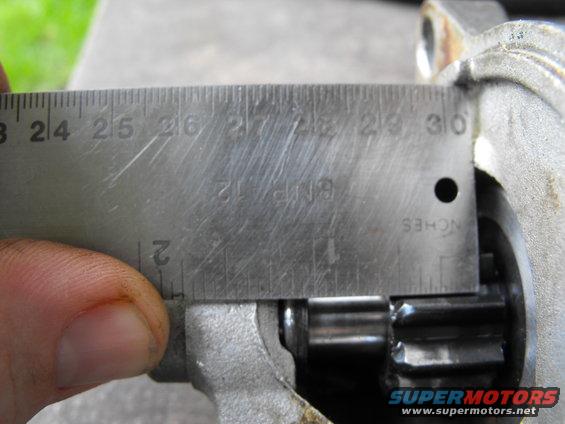 dscf1845.jpg The used junkyard starter has a much longer shaft, allowing it to engage the ring gear. The used shaft is 1.0625 inches or one and one sixteenth inch 1 1/16. Considering the ring gear teeth are barely half and inch deep that would seem to be the trouble.