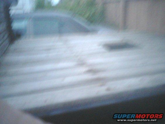 Overhead view of a weathered flatbed truck with some debris on it