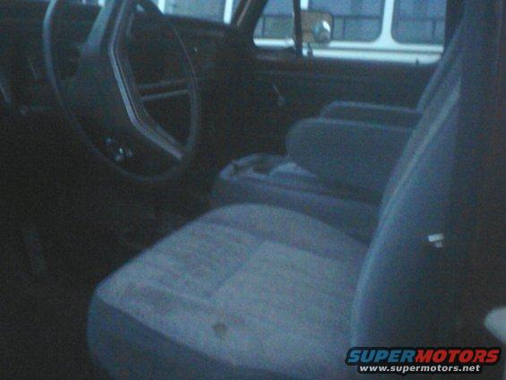 Interior shot of a vehicle's front seats and steering wheel