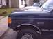 1990 Ford Bronco - Close-up of a 1990 Ford Bronco's side, highlighting the fender, wheel, and "Bronco" badging.