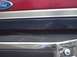 1990 Ford Bronco - Close-up of a red Ford Bronco's rear, showing the emblem and bumper details.