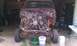 1994 Ford F-250 - This truck is missing its body panels and is in a state of disassembly in a garage.