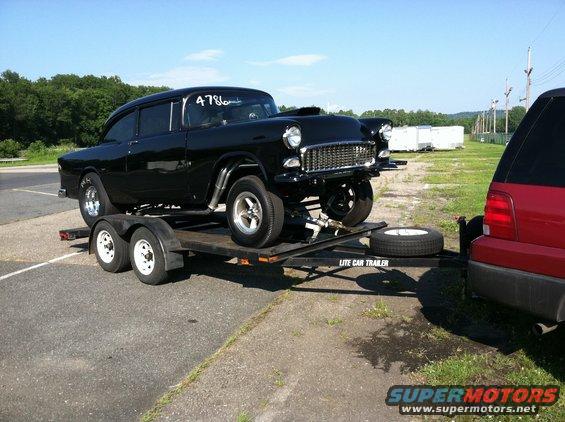 Black 1955 Chevrolet Bel Air drag car on trailer